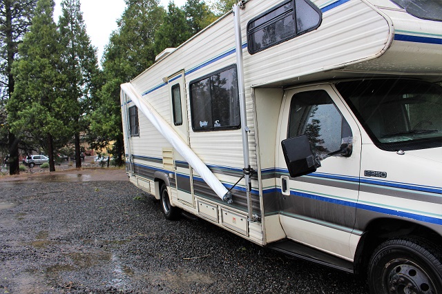 wind broken awning hanging on RV